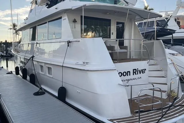 Moor River Yacht Photos Pics 1997 Hatteras 70 Sport Deck Motor Yacht docked at marina, rear view.