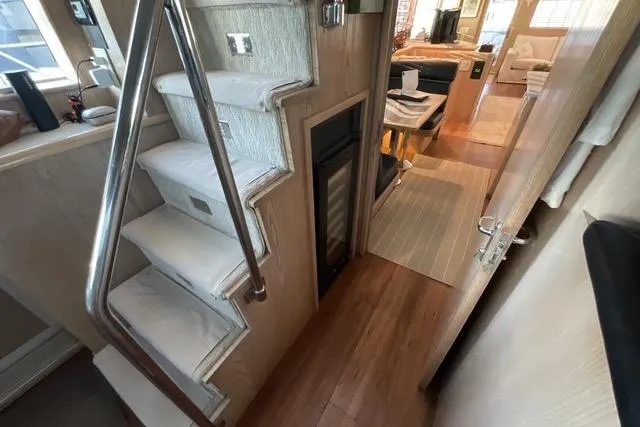 Moor River Yacht Photos Pics Interior of 1997 Hatteras 70 Sport Deck Motor Yacht with stairs and modern decor.