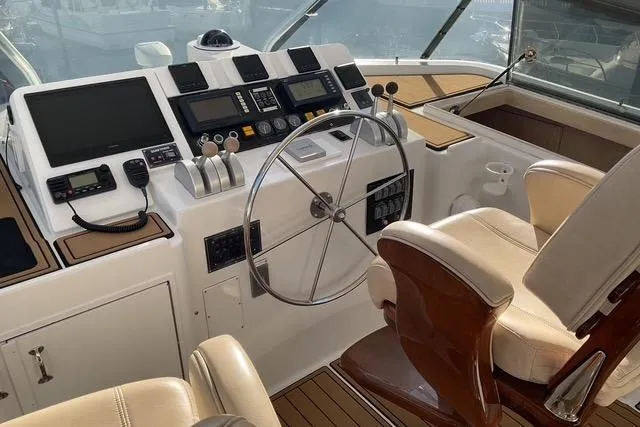 Moor River Yacht Photos Pics 1997 Hatteras 70 Sport Deck Motor Yacht helm with modern controls and leather seating.