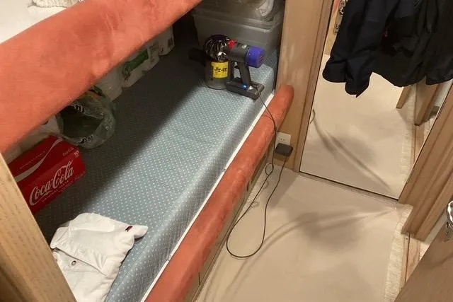 Moor River Yacht Photos Pics Interior of 1997 Hatteras 70 Sport Deck Motor Yacht with storage and cleaning supplies.