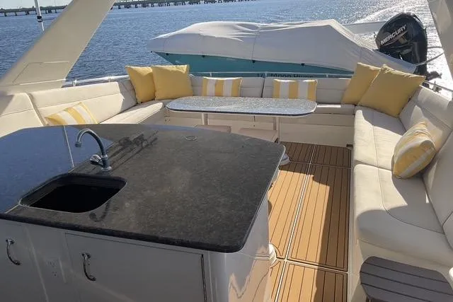 Moor River Yacht Photos Pics Luxurious 1997 Hatteras 70 Sport Deck Motor Yacht with elegant seating and modern amenities.