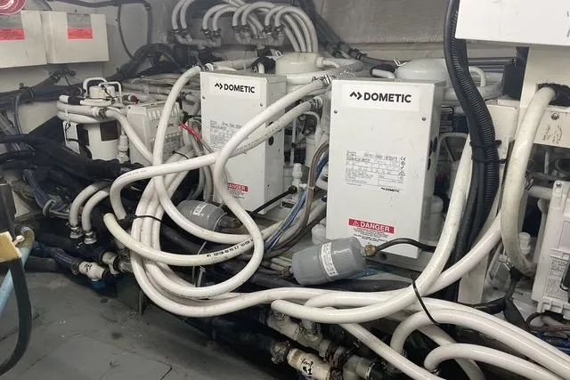 Moor River Yacht Photos Pics Engine room of 1997 Hatteras 70 Sport Deck Motor Yacht with Dometic systems and complex piping.