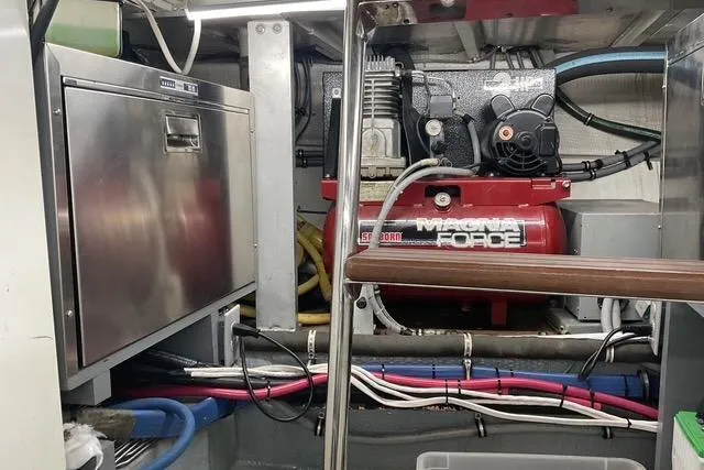 Moor River Yacht Photos Pics Engine room of 1997 Hatteras 70 Sport Deck Motor Yacht with machinery and wiring.