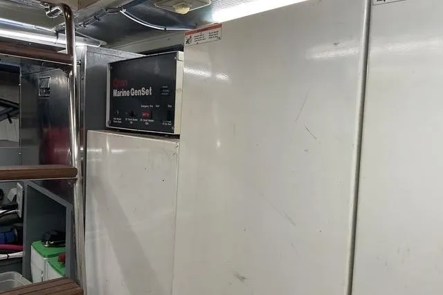 Moor River Yacht Photos Pics Engine room of 1997 Hatteras 70 Sport Deck Motor Yacht with Marine GenSet.