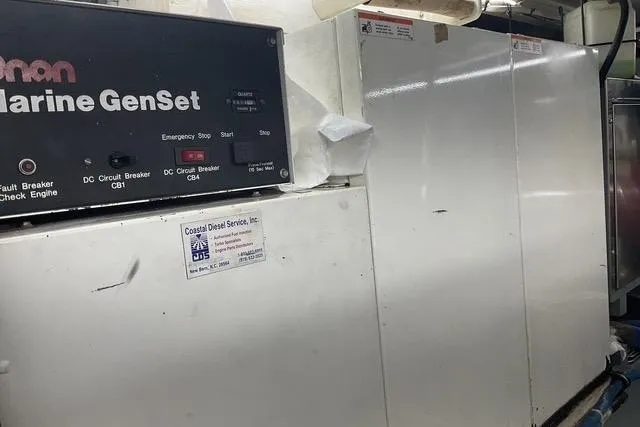 Moor River Yacht Photos Pics Engine room of 1997 Hatteras 70 Sport Deck Motor Yacht with Onan Marine GenSet.