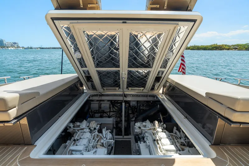 Yours Yacht Photos Pics Engine compartment of 2016 CNM Continental Tender yacht, open hatch, scenic water backdrop.