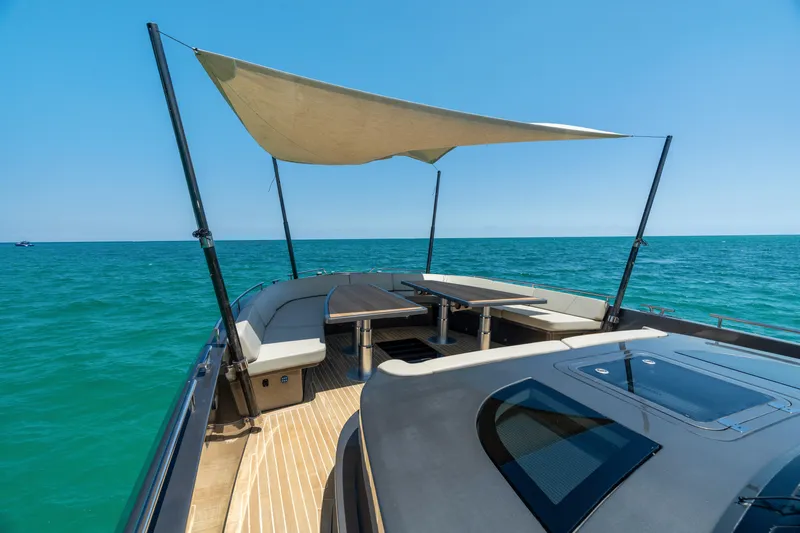 Yours Yacht Photos Pics Luxury CNM Continental Tender 2016 yacht with sunshade, cruising on clear blue ocean waters.