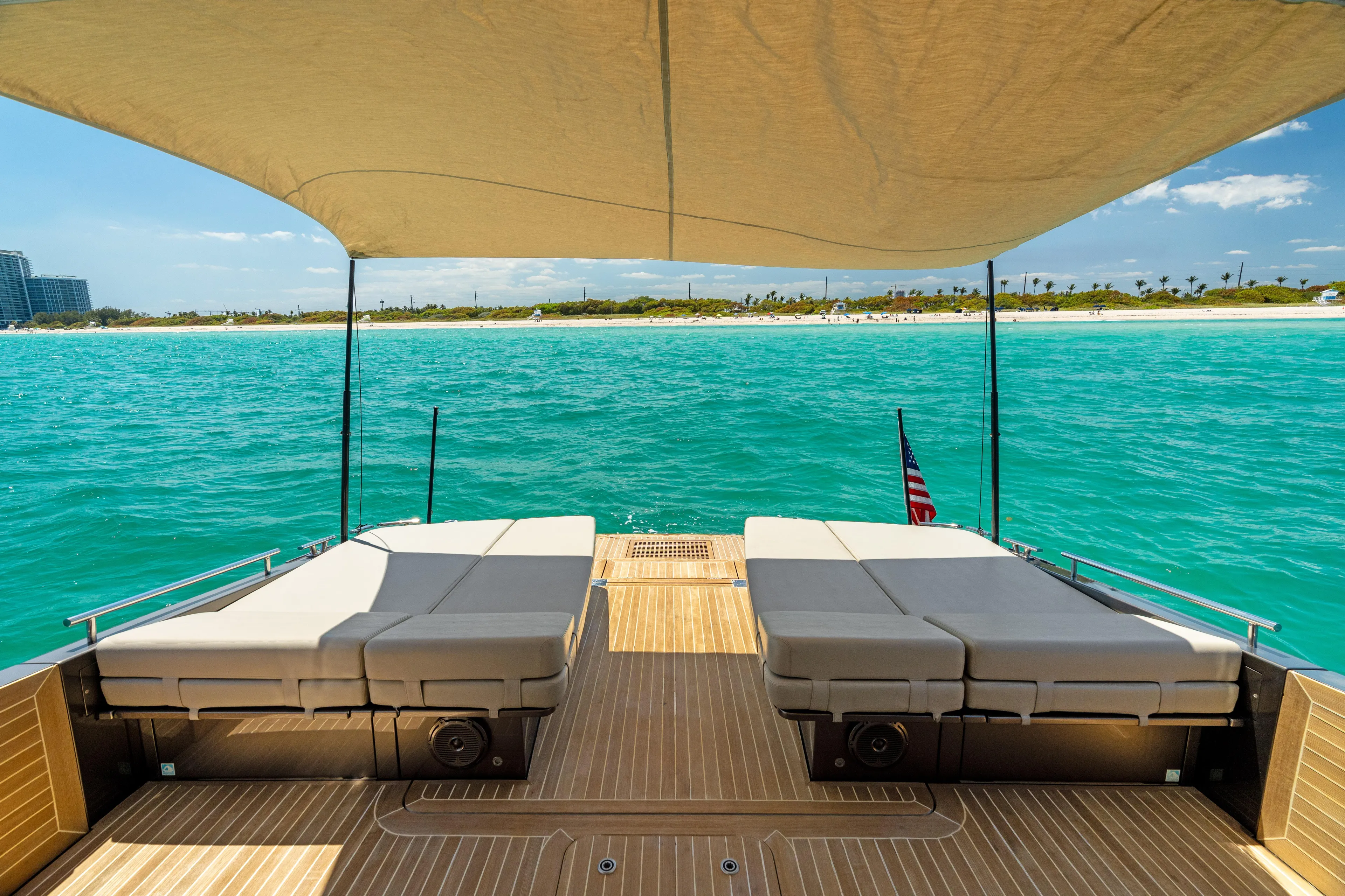 Yours Yacht Photos Pics Luxurious 2016 CNM Continental Tender yacht with sunbeds, overlooking turquoise ocean and sandy beach.