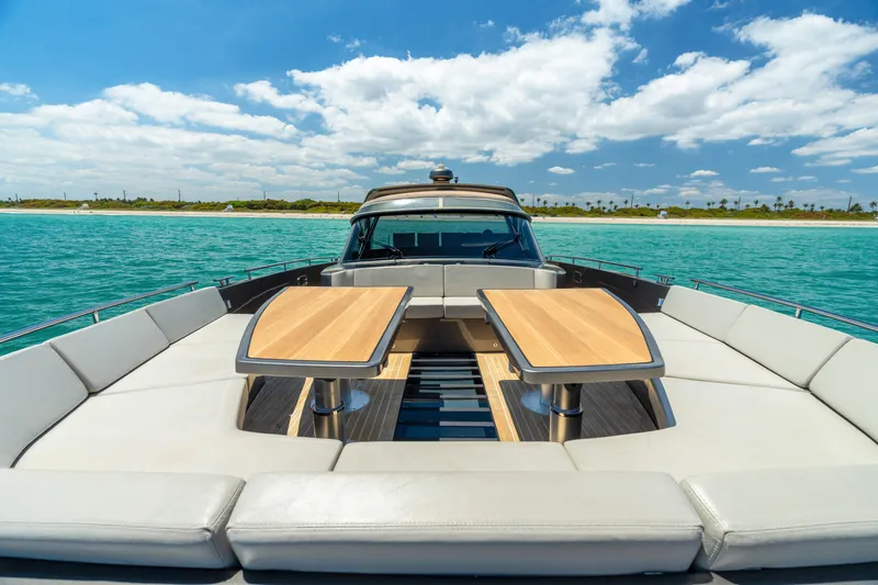 Yours Yacht Photos Pics Luxury CNM Continental Tender 2016 yacht with spacious deck, wooden tables, and ocean view.