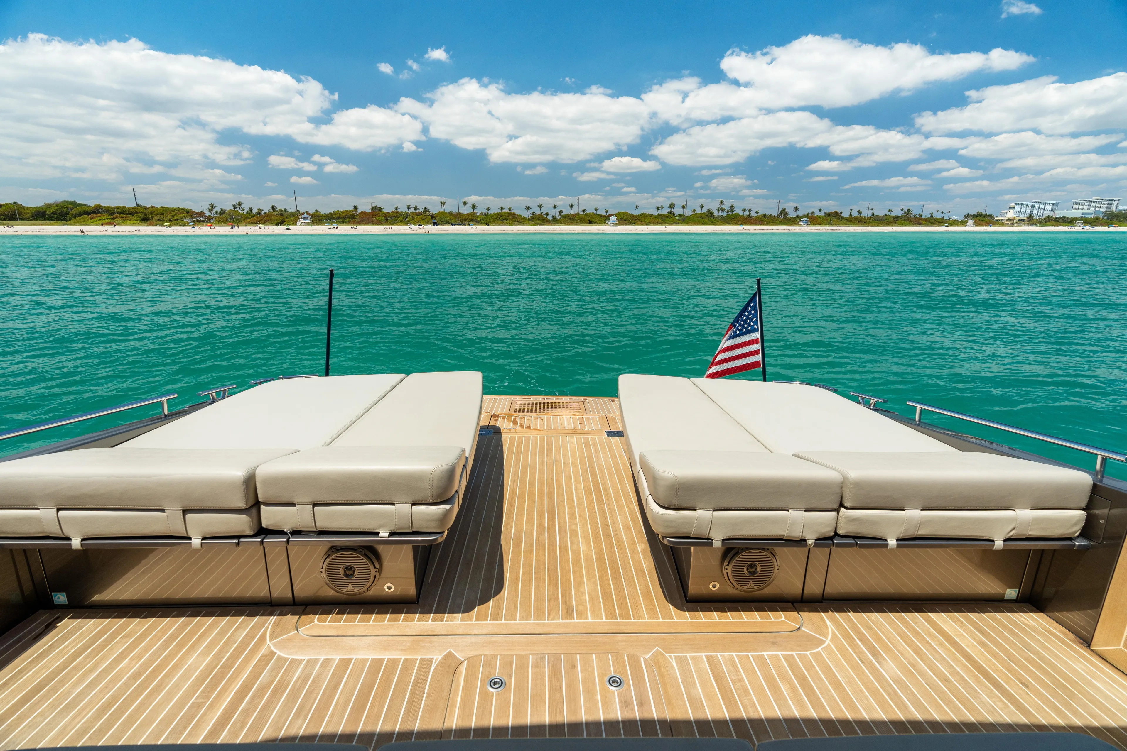 Yours Yacht Photos Pics Luxury CNM Continental Tender 2016 yacht deck with sunbeds, ocean view, and American flag.