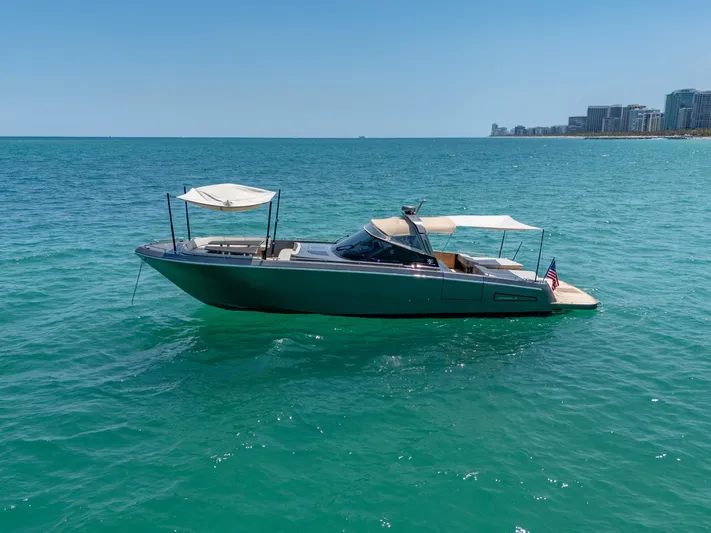 Yours Yacht Photos Pics 2016 CNM Continental Tender yacht on clear blue ocean near coastline.