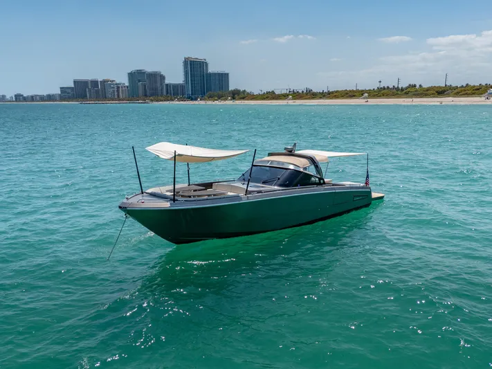 Yours Yacht Photos Pics Luxury 2016 CNM Continental Tender boat on turquoise water near urban skyline.