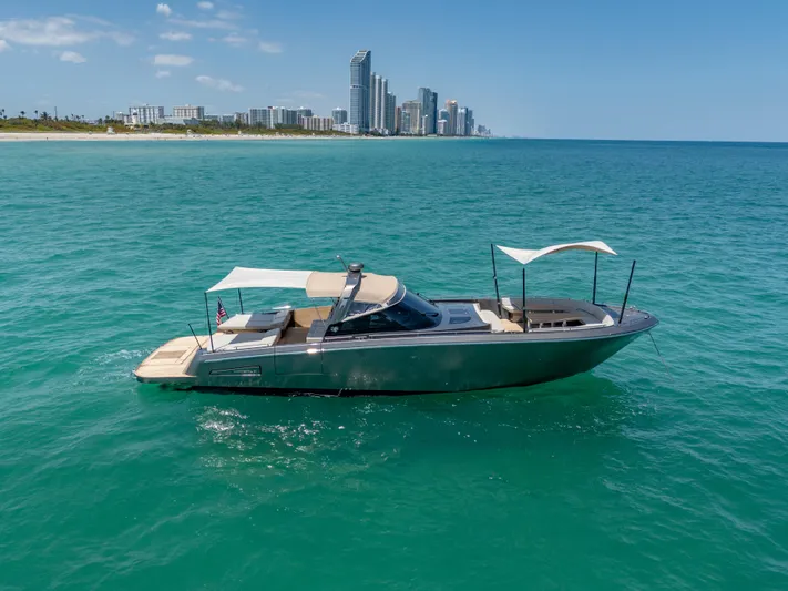 Yours Yacht Photos Pics 2016 CNM Continental Tender yacht cruising near a city skyline on clear blue waters.