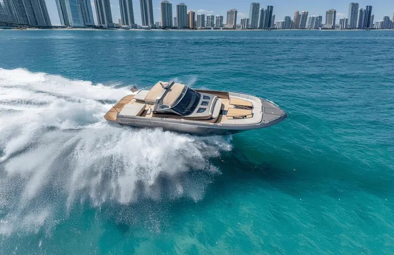 Yours Yacht Photos Pics Luxury CNM Continental Tender 2016 yacht cruising in turquoise waters near city skyline.