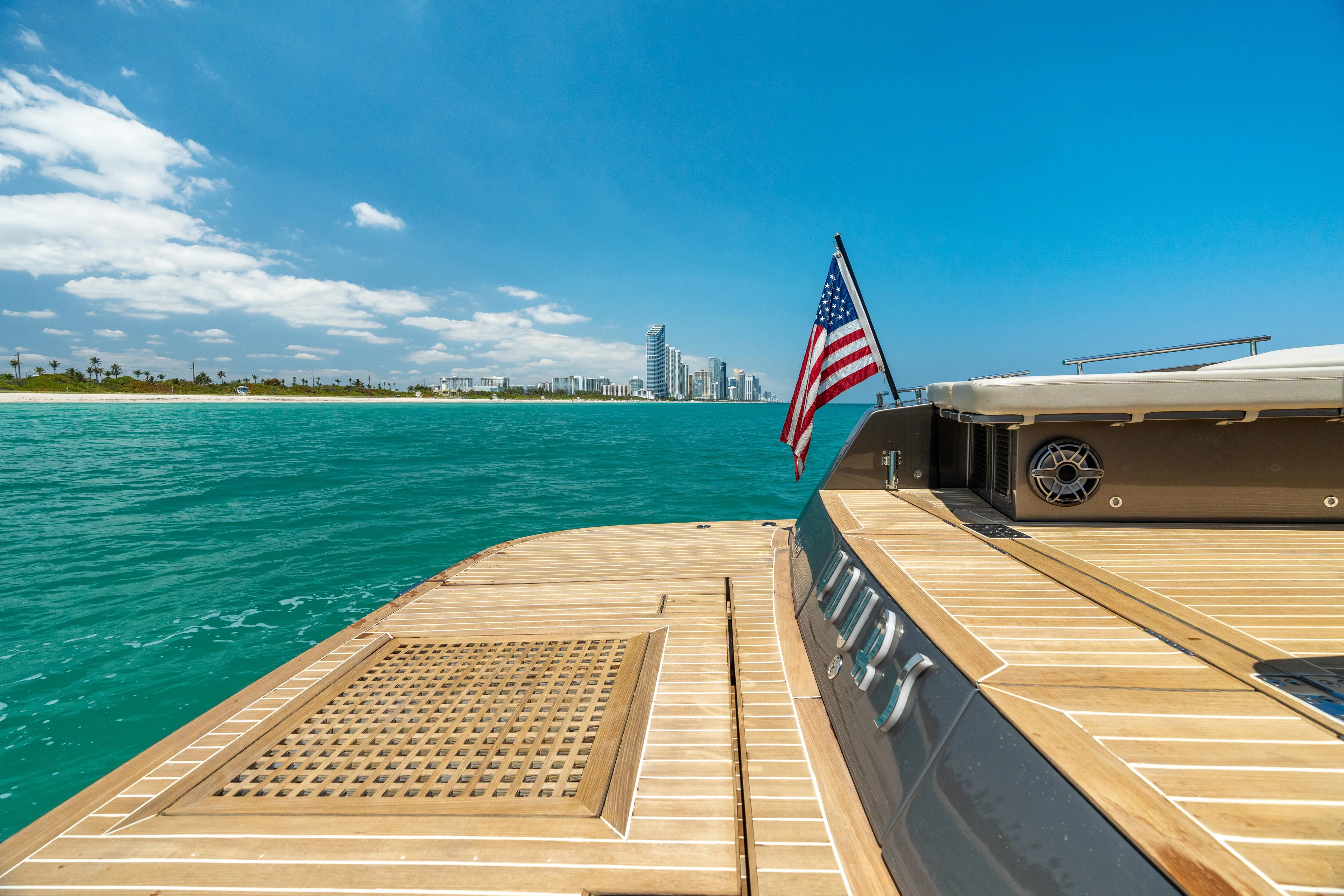 Yours Yacht Photos Pics Luxury yacht deck with American flag, ocean view, and city skyline; CNM Continental Tender 2016.