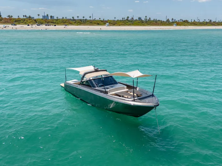 Yours Yacht Photos Pics Luxury CNM Continental Tender 2016 yacht anchored in turquoise waters near a sandy beach.