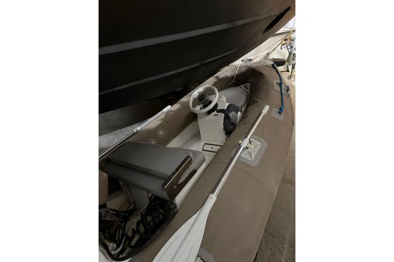  Yacht Photos Pics Inflatable boat under a 1994 Ferretti Yachts 185 Fly, featuring steering wheel and oar.