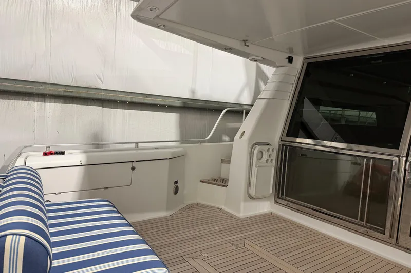  Yacht Photos Pics Interior view of 1994 Ferretti Yachts 185 Fly with striped seating and wooden flooring.