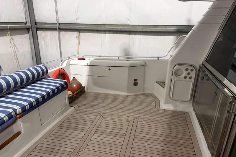  Yacht Photos Pics 1994 Ferretti Yachts 185 Fly deck with striped seating and safety equipment.