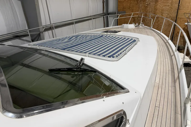  Yacht Photos Pics 1994 Ferretti Yachts 185 Fly deck with striped sunpad and sleek design.