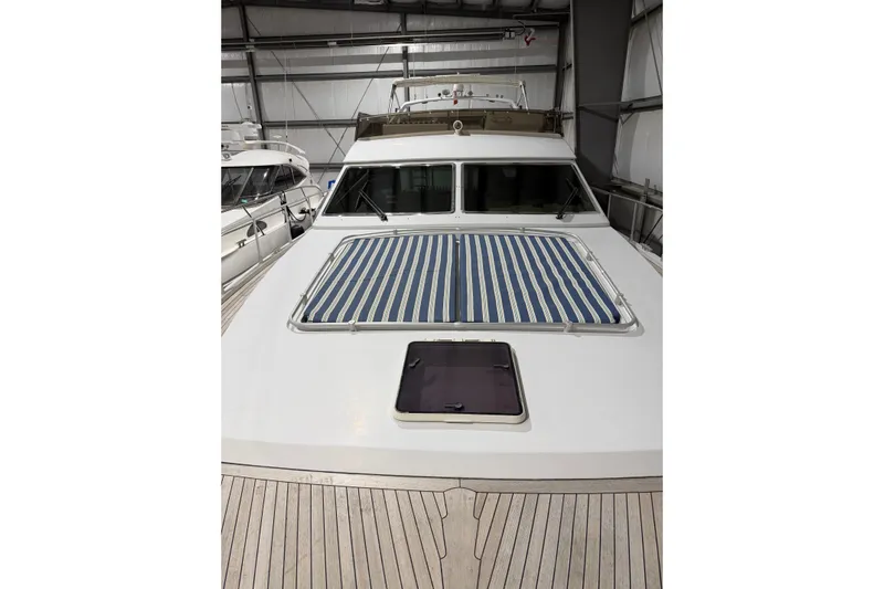  Yacht Photos Pics 1994 Ferretti Yachts 185 Fly in storage, featuring striped sunpad and sleek design.