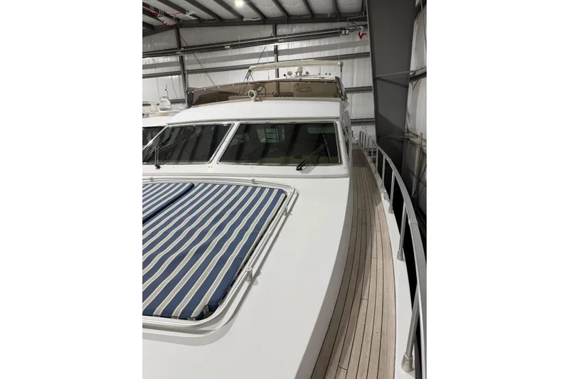  Yacht Photos Pics 1994 Ferretti Yachts 185 Fly in storage, featuring sleek design and striped deck cushion.