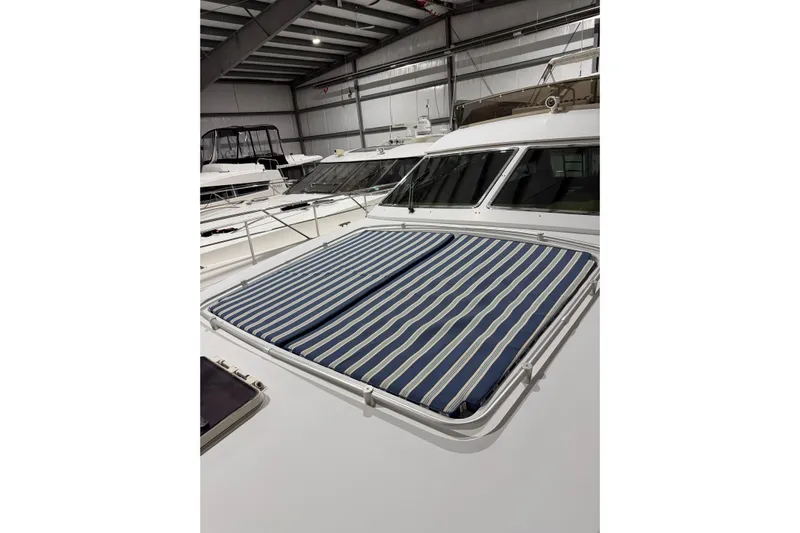  Yacht Photos Pics 1994 Ferretti Yachts 185 Fly with striped sunpad in a storage facility.