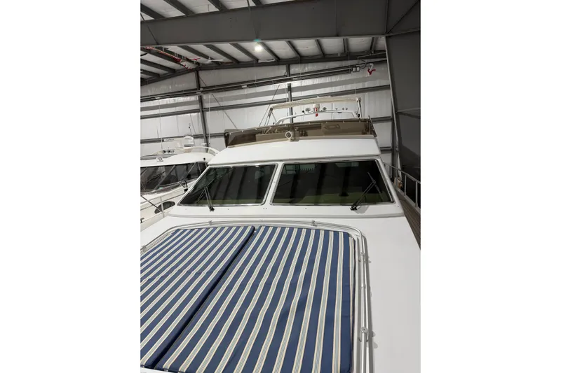  Yacht Photos Pics 1994 Ferretti Yachts 185 Fly in storage, featuring striped deck cover.