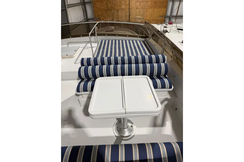  Yacht Photos Pics 1994 Ferretti Yachts 185 Fly with striped seating and table on deck.