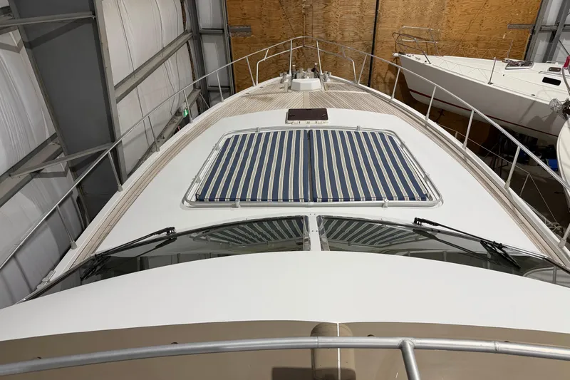  Yacht Photos Pics 1994 Ferretti Yachts 185 Fly in storage, showcasing deck and striped sunroof.