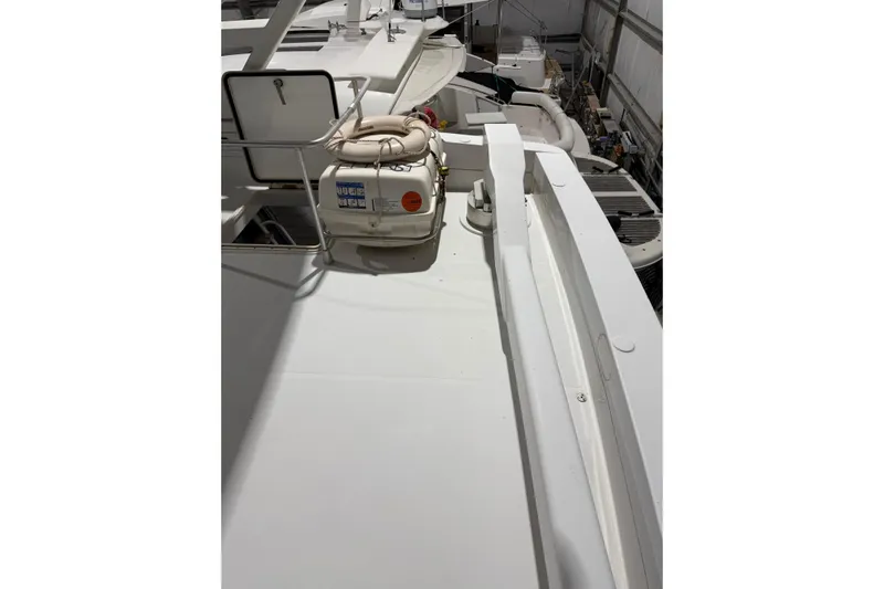  Yacht Photos Pics 1994 Ferretti Yachts 185 Fly deck with life raft, docked indoors.