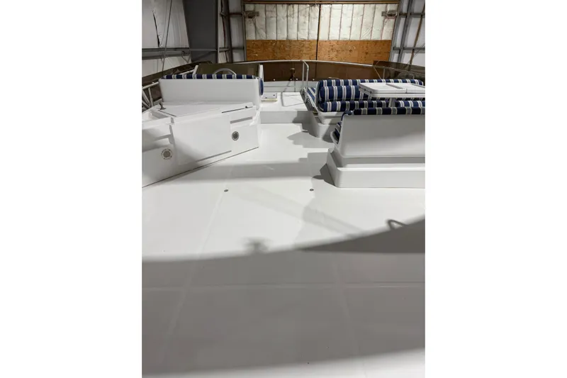  Yacht Photos Pics 1994 Ferretti Yachts 185 Fly deck with striped cushions in a storage facility.