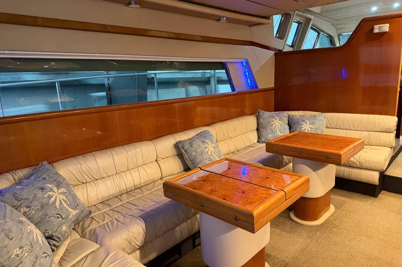  Yacht Photos Pics Luxurious interior of 1994 Ferretti Yachts 185 Fly with plush seating and wooden tables.