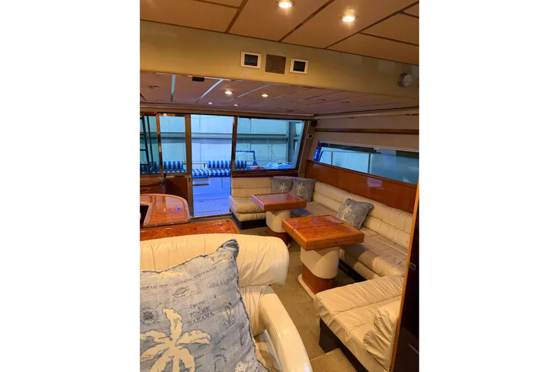  Yacht Photos Pics Luxurious interior of 1994 Ferretti Yachts 185 Fly with plush seating and wooden tables.