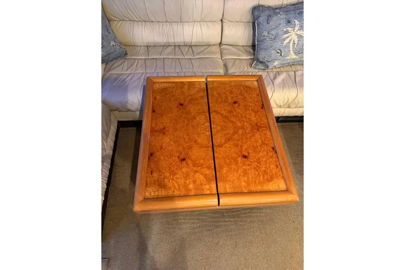  Yacht Photos Pics Wooden table on Ferretti Yachts 185 Fly, 1994, with white leather seating and decorative pillows.