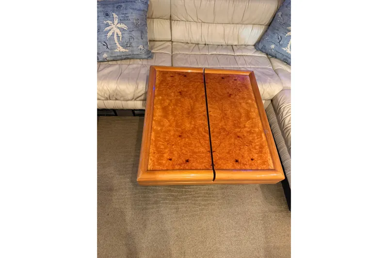  Yacht Photos Pics Luxurious wooden table on Ferretti Yachts 185 Fly, 1994 model, with plush seating.