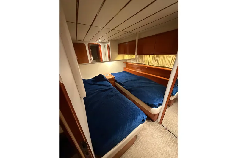  Yacht Photos Pics 1994 Ferretti Yachts 185 Fly cabin with twin beds and blue bedding.