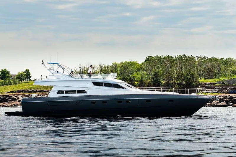  Yacht Photos Pics 1994 Ferretti Yachts 185 Fly cruising near a lush, green shoreline.