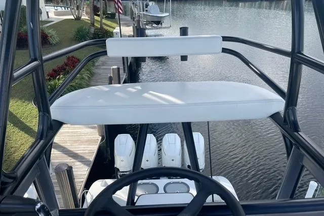  Yacht Photos Pics 2023 Conch 41 Center Console boat with helm view, docked by a serene waterfront.