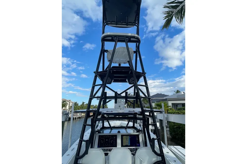  Yacht Photos Pics 2023 Conch 41 Center Console boat with tower, docked under a blue sky.