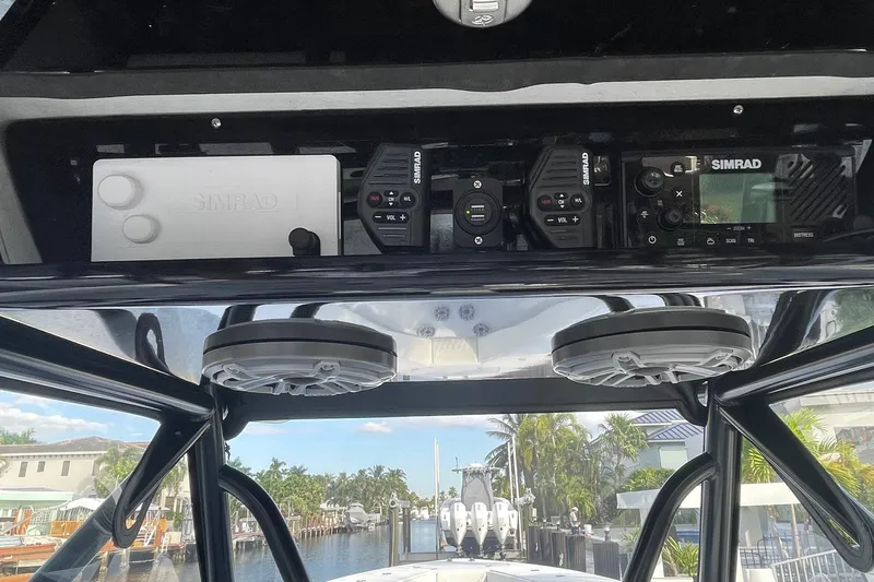  Yacht Photos Pics 2023 Conch 41 Center Console boat with Simrad electronics and speakers, docked near waterfront homes.