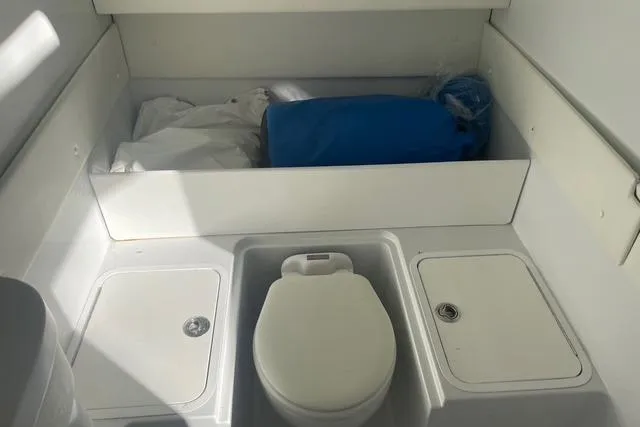  Yacht Photos Pics 2023 Conch 41 Center Console boat interior with storage and toilet.