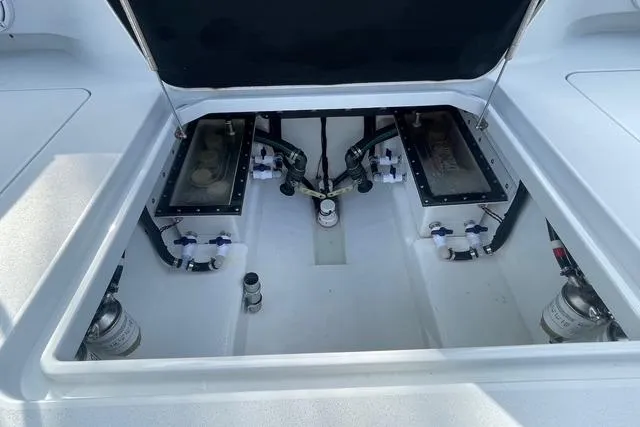  Yacht Photos Pics 2023 Conch 41 Center Console boat engine compartment with open hatch, showcasing internal components.