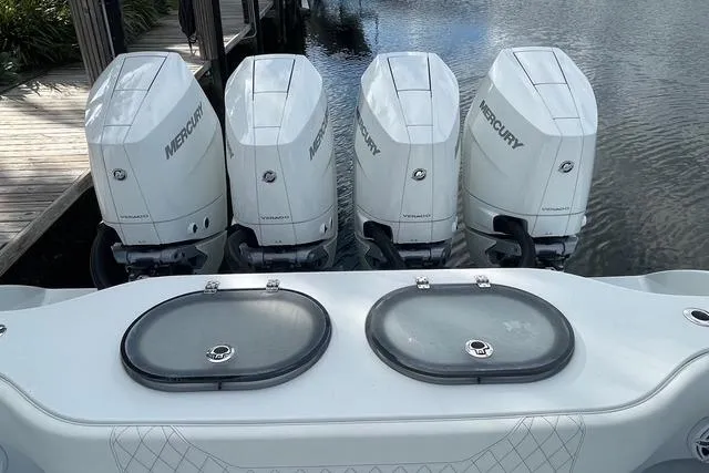  Yacht Photos Pics 2023 Conch 41 Center Console with four Mercury outboard engines docked by water.