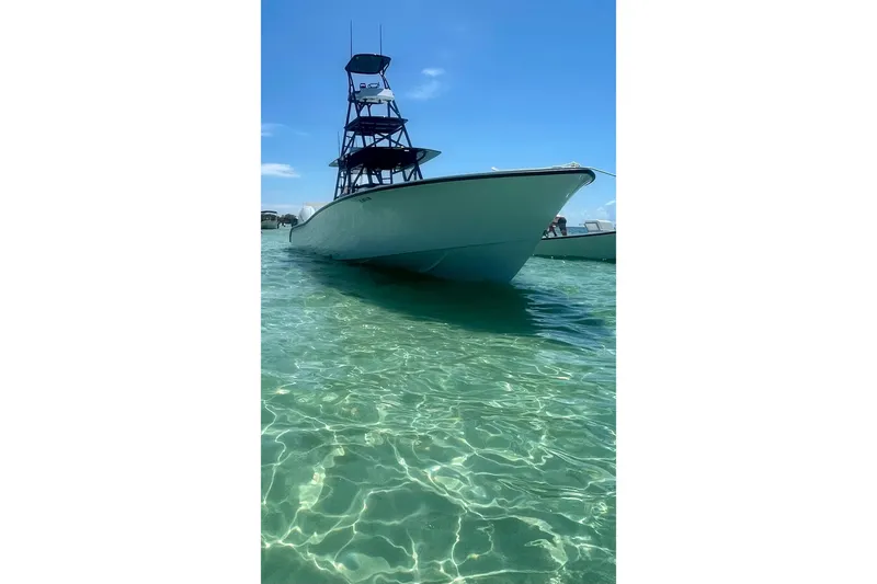  Yacht Photos Pics 2023 Conch 41 Center Console boat in clear turquoise water under blue sky.