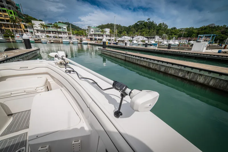 Half Nelson Yacht Photos Pics Boat docked in marina, Jupiter HFS 2016 model, surrounded by calm water and lush greenery.