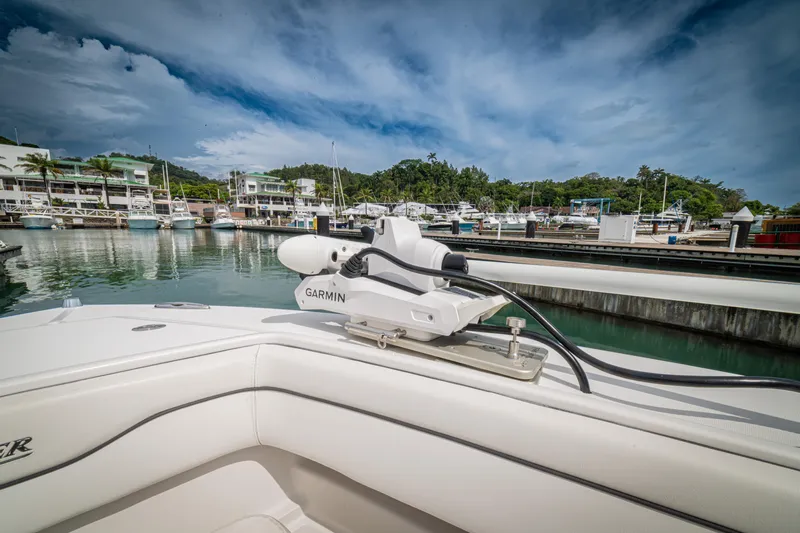 Half Nelson Yacht Photos Pics Boat with Garmin equipment docked at marina, surrounded by lush greenery and buildings.