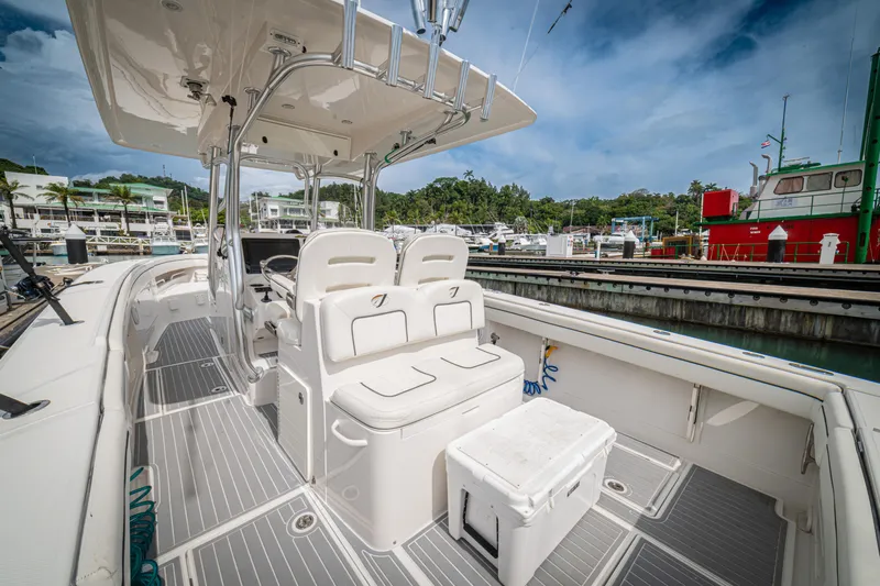 Half Nelson Yacht Photos Pics 2016 Jupiter HFS boat interior with seating, docked at marina under blue sky.