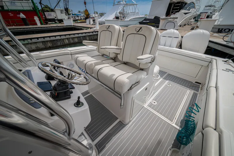 Half Nelson Yacht Photos Pics Luxury boat interior with dual captain's chairs, steering wheel, and modern controls, Jupiter HFS 2016 model.