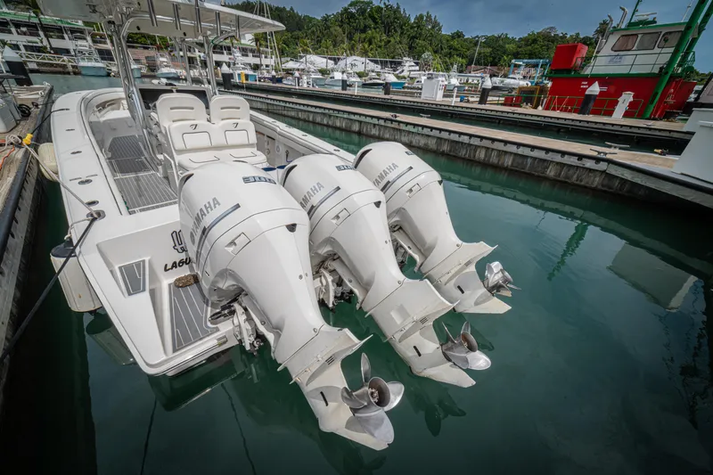 Half Nelson Yacht Photos Pics A 2016 Jupiter HFS boat with triple Yamaha outboard engines docked in a marina.